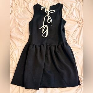 boutique black dress with white ties on the back